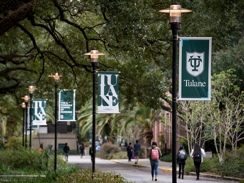 Banners line a sidewalk on Tulane's uptown campus. 